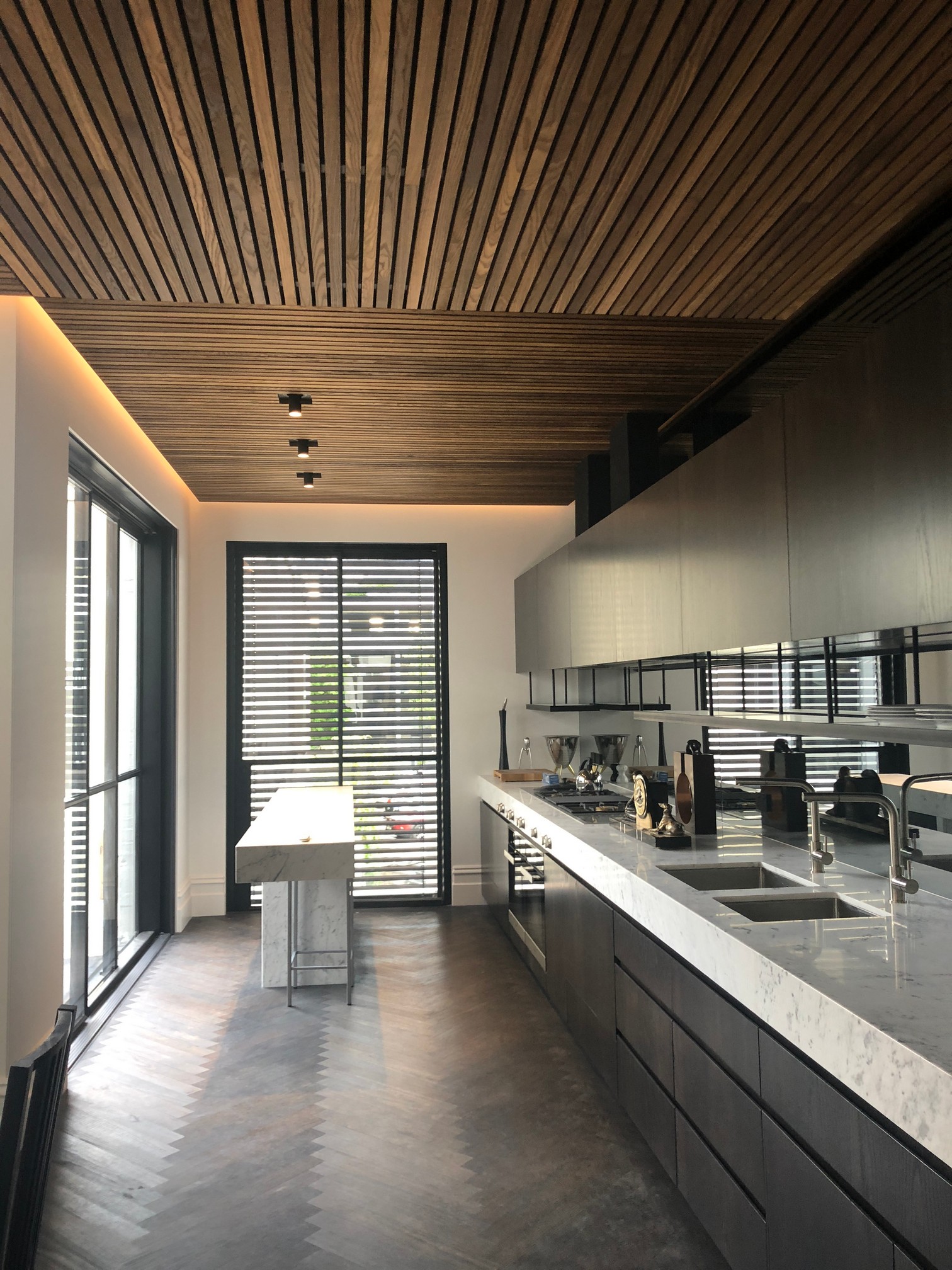 Avoca Street kitchen with long stone bench and timber slat ceiling
