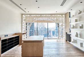 Living area of the South Yarra apartment with arched window and garden outlook