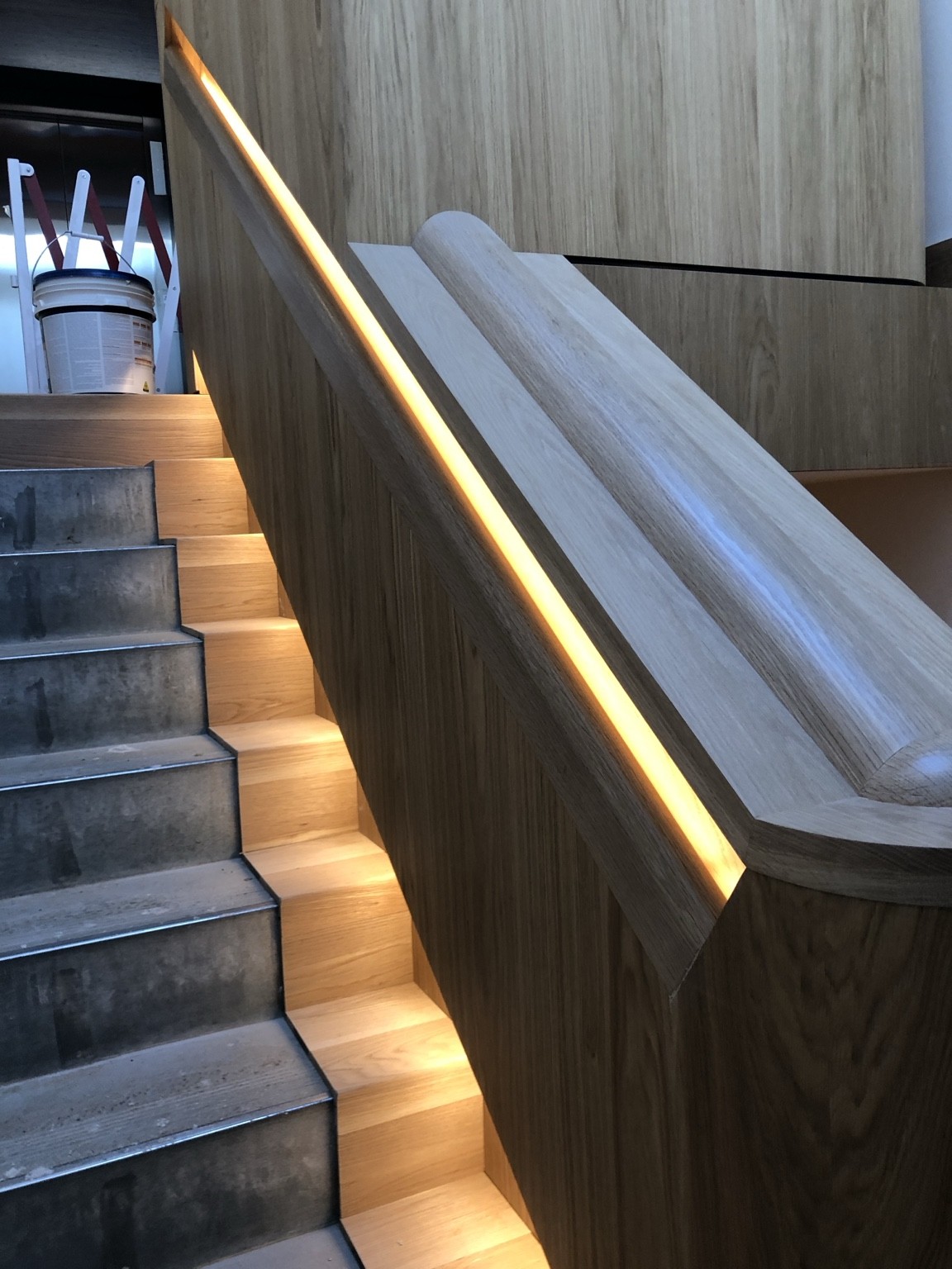South Yarra apartment staircase with integrated warm lighting and timber detailing